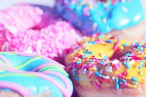 Close-up of assorted donuts with colorful icing and sprinkles, showcasing sweet indulgence. jigsaw puzzle