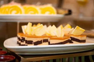 Exquisite chocolate and caramel layered pastries garnished with white chocolate on a serving plate. jigsaw puzzle