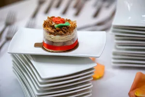 A gourmet dessert elegantly presented on stacked white plates, perfect for culinary displays. jigsaw puzzle