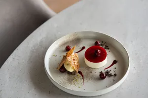 A sophisticated dessert with cherry garnish presented elegantly in a Tokyo restaurant. jigsaw puzzle