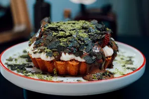 Indulge in a luscious chocolate dessert topped with creamy frosting and sprinkles. jigsaw puzzle