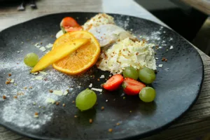 A delectable dessert plate featuring fresh fruits and cream, perfect for food photography. jigsaw puzzle