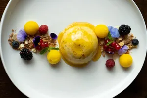 Exquisite dessert with a sweet sauce and fresh berries on a white plate. jigsaw puzzle