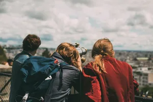 A group of young tourists exploring Paris views through a telescope during the day. jigsaw puzzle