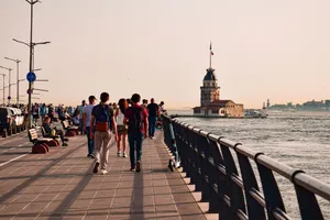 People walking along waterfront promenade in İstanbul with view of Maiden's Tower. jigsaw puzzle