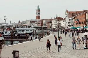 Explore vibrant life along Venice's canal promenade, with historic architecture and bustling crowds. jigsaw puzzle
