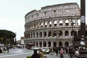 Photo of the Colosseum in Rome, Italy, with a lively street scene in the foreground. jigsaw puzzle