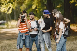 A group of young adults hiking and exploring with a map and camera in a forest setting. jigsaw puzzle