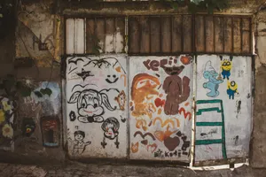 Vibrant graffiti on an aged wooden doorway, featuring cartoon characters and abstract art. jigsaw puzzle