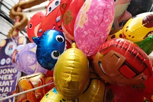 Vibrant collection of inflatable character balloons at a festive indoor event. jigsaw puzzle