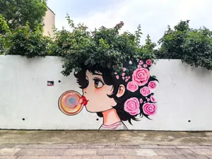 Colorful street art mural of a girl blowing a bubble, adorned with roses. jigsaw puzzle