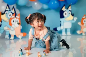 Adorable toddler enjoying a cartoon-themed celebration with colorful decorations. jigsaw puzzle