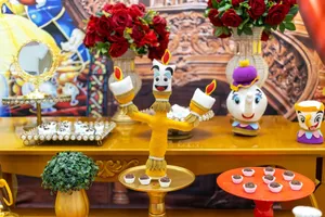 Vibrant party table featuring animated character decor with candles and roses. jigsaw puzzle
