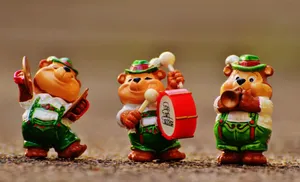 Three adorable bear figurines dressed as musicians in traditional costumes playing music instruments. jigsaw puzzle
