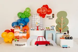 Vibrant cartoon-themed decoration setup for a child's birthday party with balloons and toy cars. jigsaw puzzle