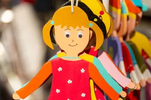 Close-up of vibrant wooden dolls on display, capturing a festive atmosphere. jigsaw puzzle