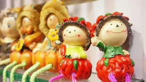 Close-up of colorful decorative dolls with cheerful expressions, perfect for home décor. jigsaw puzzle
