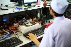 A technician in uniform working on a motherboard at a desk in a laboratory setting. jigsaw puzzle