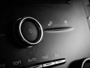 Detailed view of a round power button on a car dashboard with a sleek design. jigsaw puzzle