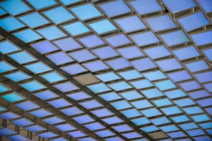 A modern ceiling installation featuring a grid of illuminated blue panels creating an abstract geometric pattern. jigsaw puzzle