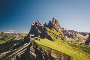 Majestic Seceda peaks in the Italian Dolomites under a clear blue sky, showcasing dramatic landscapes. jigsaw puzzle