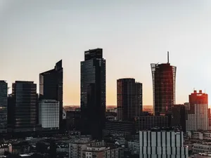 Silhouetted skyscrapers create a dramatic sunset skyline in a modern cityscape. jigsaw puzzle