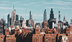Captivating view of New York City's skyline featuring iconic skyscrapers under a clear blue sky. jigsaw puzzle