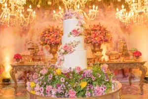 A beautifully decorated quinceanera setting with a stunning floral cake and luxurious decorations. jigsaw puzzle