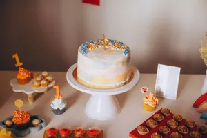 Colorful first birthday cake setup with cupcakes, perfect for celebrations and events. jigsaw puzzle