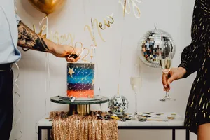 Party setting with cake, balloons, and champagne celebrating the New Year in style. jigsaw puzzle