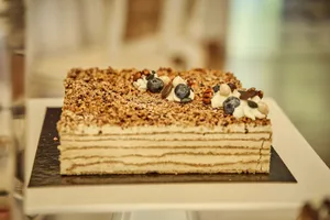 A delectable layered cake topped with blueberries and nuts, perfect for dessert enthusiasts. jigsaw puzzle