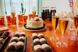 Celebrate in style with a festive table featuring a cake, drinks, and desserts. Perfect for cheerful gatherings. jigsaw puzzle