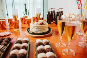 A beautifully arranged table with cake, assorted drinks, and desserts for a festive birthday celebration. jigsaw puzzle