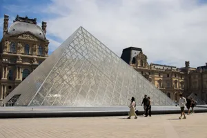 The iconic Louvre Pyramid beneath a blue sky in Paris, France. jigsaw puzzle