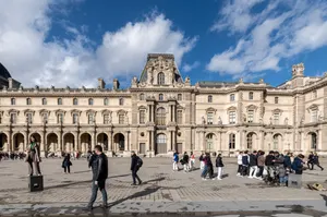 A vibrant scene outside the Louvre Museum in Paris showcasing its classic architecture and visiting tourists. jigsaw puzzle