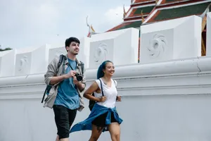 A cheerful couple exploring an outdoor landmark with traditional architecture. jigsaw puzzle