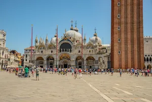 A vibrant crowd in Saint Mark's Square, Venice with the iconic Basilica and bell tower. jigsaw puzzle