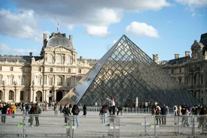 Visitors gather around the iconic Louvre Pyramid in Paris, France. jigsaw puzzle