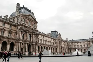 Exterior view of the historic Louvre Museum in Paris, showcasing Renaissance architecture and iconic pyramids. jigsaw puzzle