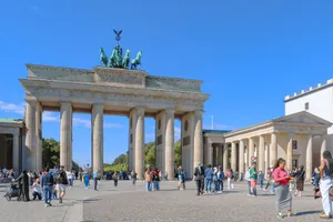 Vibrant city life around Brandenburg Gate, Berlin under a clear blue sky. jigsaw puzzle