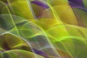 Dynamic abstract image featuring colorful, blurred wave patterns in green, yellow, and purple hues. jigsaw puzzle