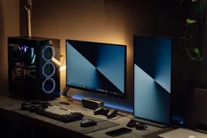 Modern dual monitor PC setup with tech gadgets on a sleek desk in a dimly lit room. jigsaw puzzle