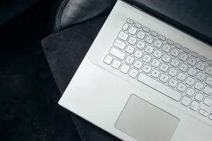 Top view of a sleek white laptop on a leather car seat, emphasizing modern technology and style. jigsaw puzzle
