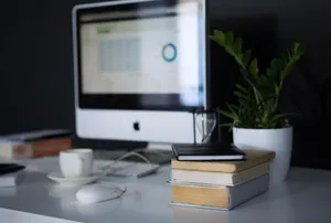 A sleek modern office setup featuring a computer, books, and a coffee cup on a desk. jigsaw puzzle