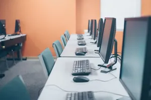 Contemporary style office with computers and keyboards near mouses on tables in light workspace jigsaw puzzle