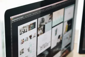 A modern computer screen displaying web design work, showcasing creative visuals in a workspace. jigsaw puzzle