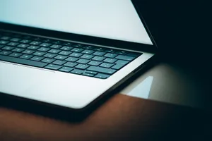 Close-up of a modern laptop keyboard with a backlit display, emphasizing sleek design. jigsaw puzzle