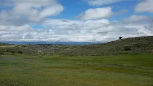 Majestic landscape in Aguilar de Campoo, Spain, featuring lush green fields under a cloudy sky. jigsaw puzzle