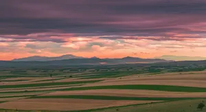 Vibrant sunset over the picturesque rolling hills of Romania, showcasing nature's beauty. jigsaw puzzle