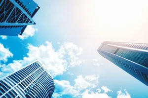 Upward view of modern skyscrapers against a vivid blue sky showcasing contemporary architecture. jigsaw puzzle